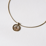 Gold necklace with a pendant on a white background