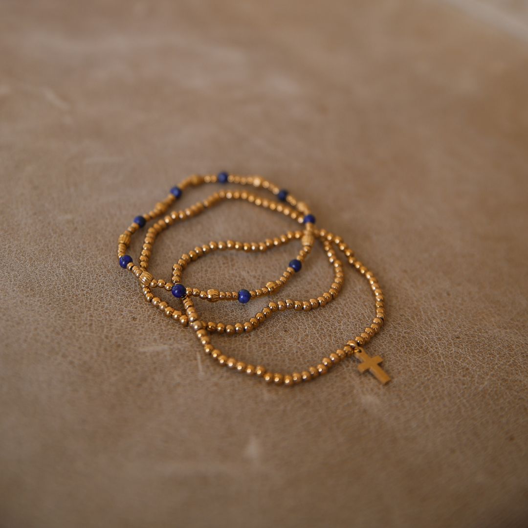 Stack of 3 gold and navy bracelets