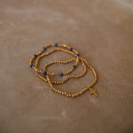 Stack of 3 gold and navy bracelets