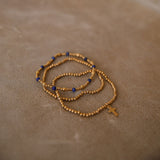 Stack of 3 gold and navy bracelets