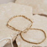 Gold bracelets on rock