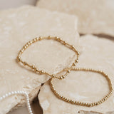 Gold bracelets on rock