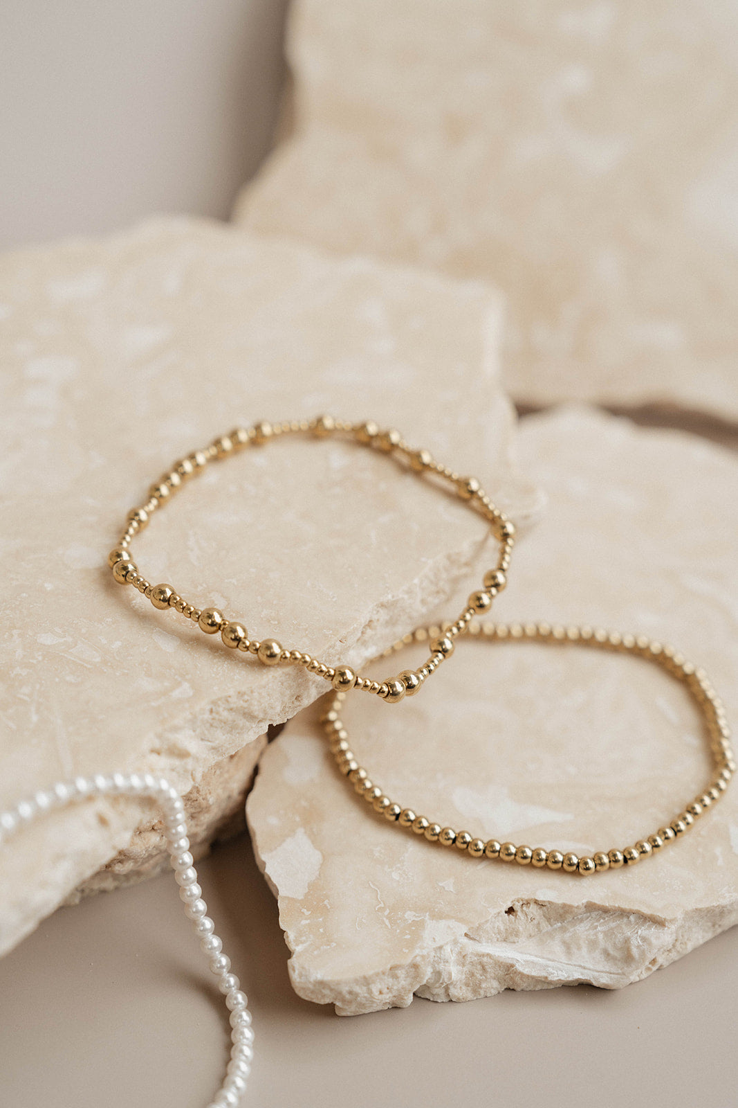 Gold bracelets on rock
