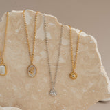 4 Catholic necklaces on rock