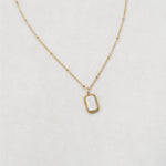 Gold foundation necklace white background