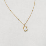Gold foundation necklace white background