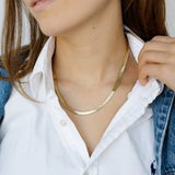 Model wearing gold necklace