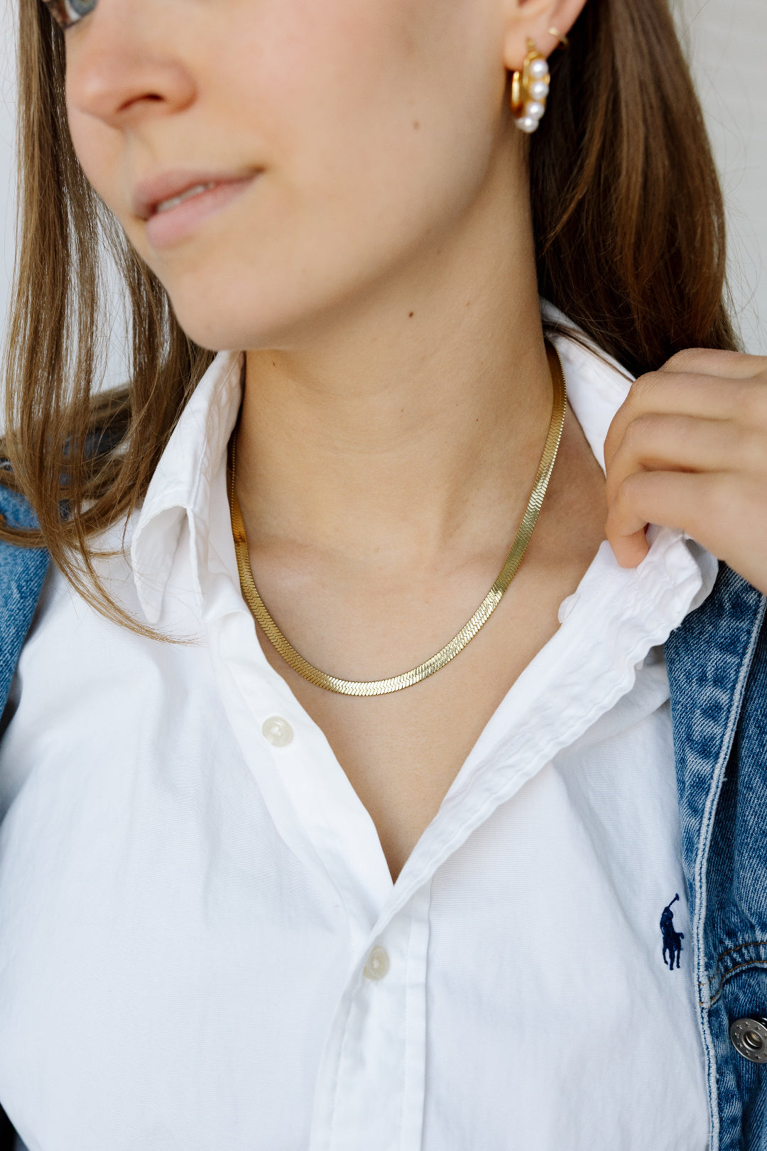 Model wearing gold necklace