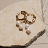 Gold pearl hoops on rock
