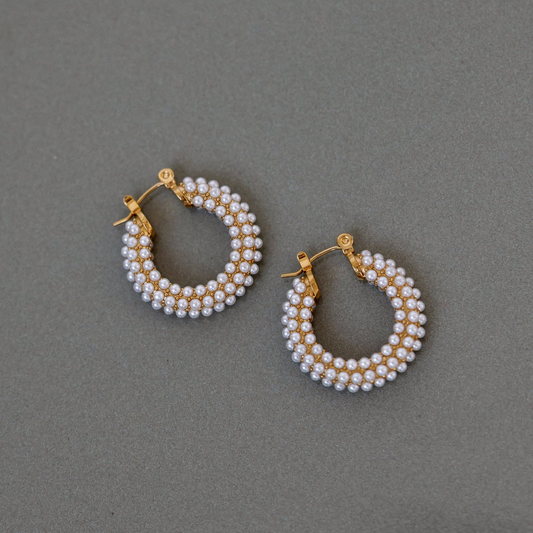 Close up of pearl hoops dark background