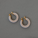 Close up of pearl hoops dark background