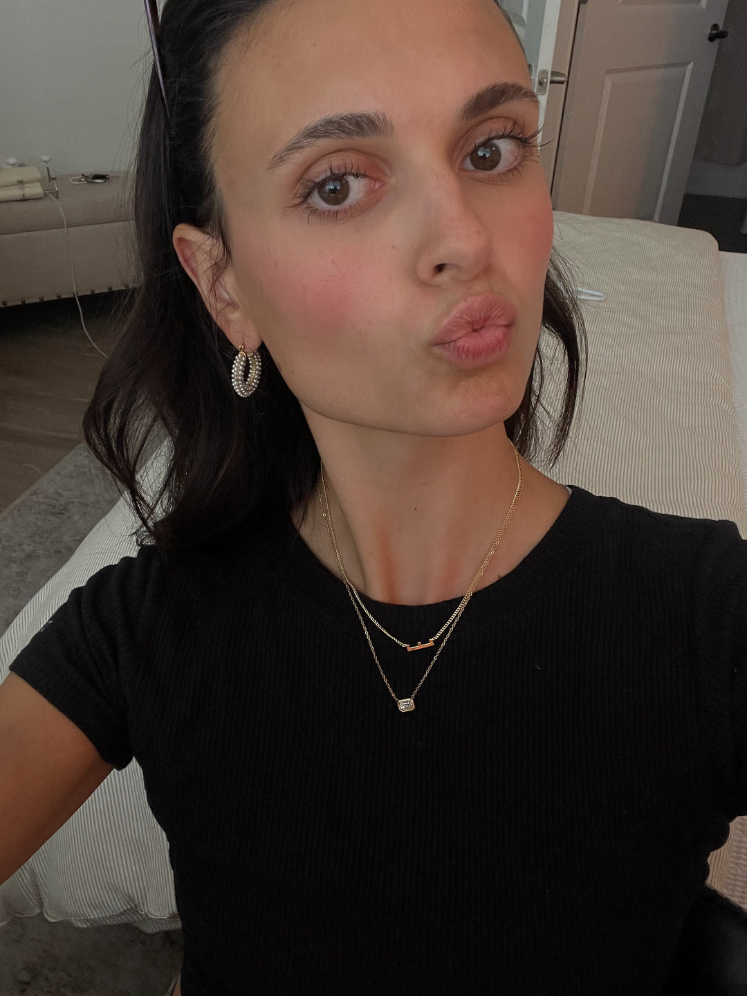 Brunette model with hoops and necklaces