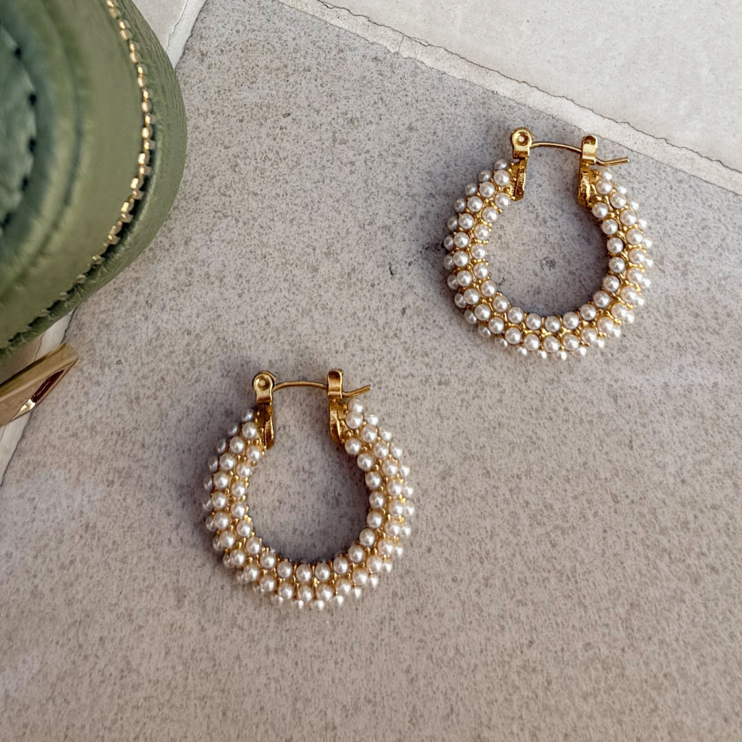 Close up of gold and pearl hoops