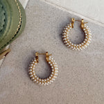 Close up of gold and pearl hoops