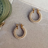 Close up of gold and pearl hoops