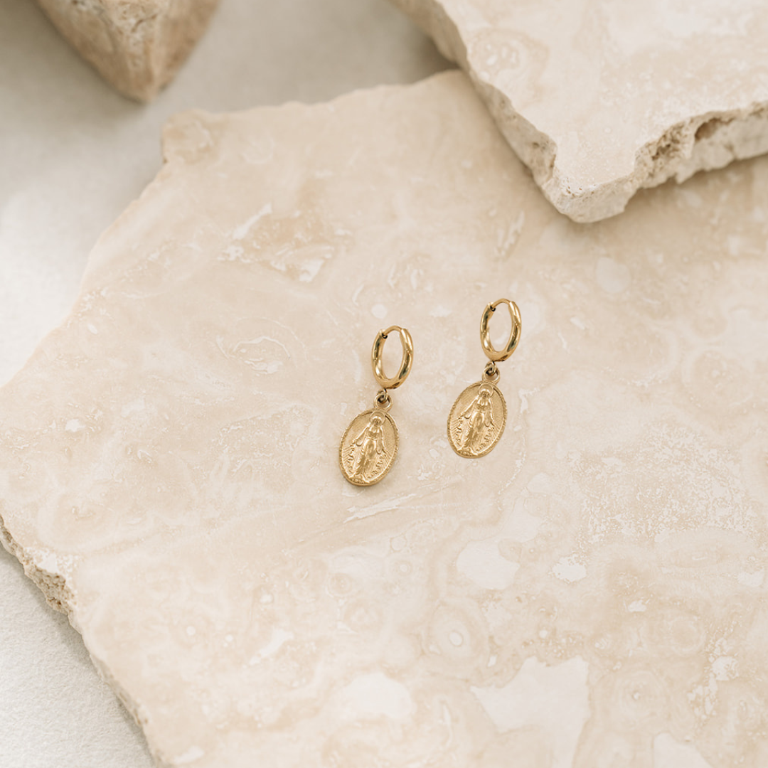 Pair of earrings laid on rock