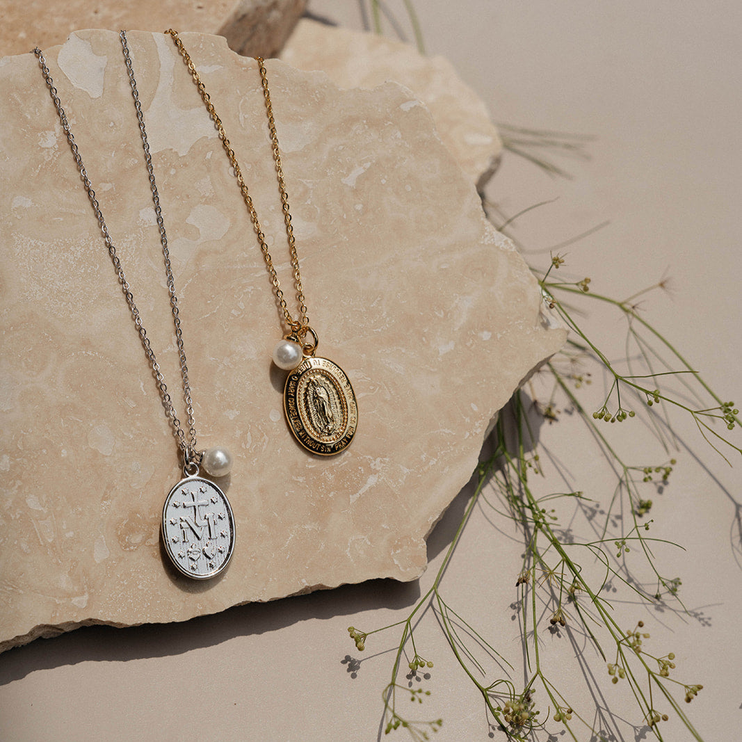 Gold and silver necklaces on rock