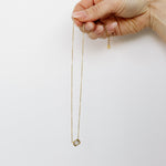 Hand holding crystal necklace