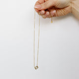 Hand holding crystal necklace