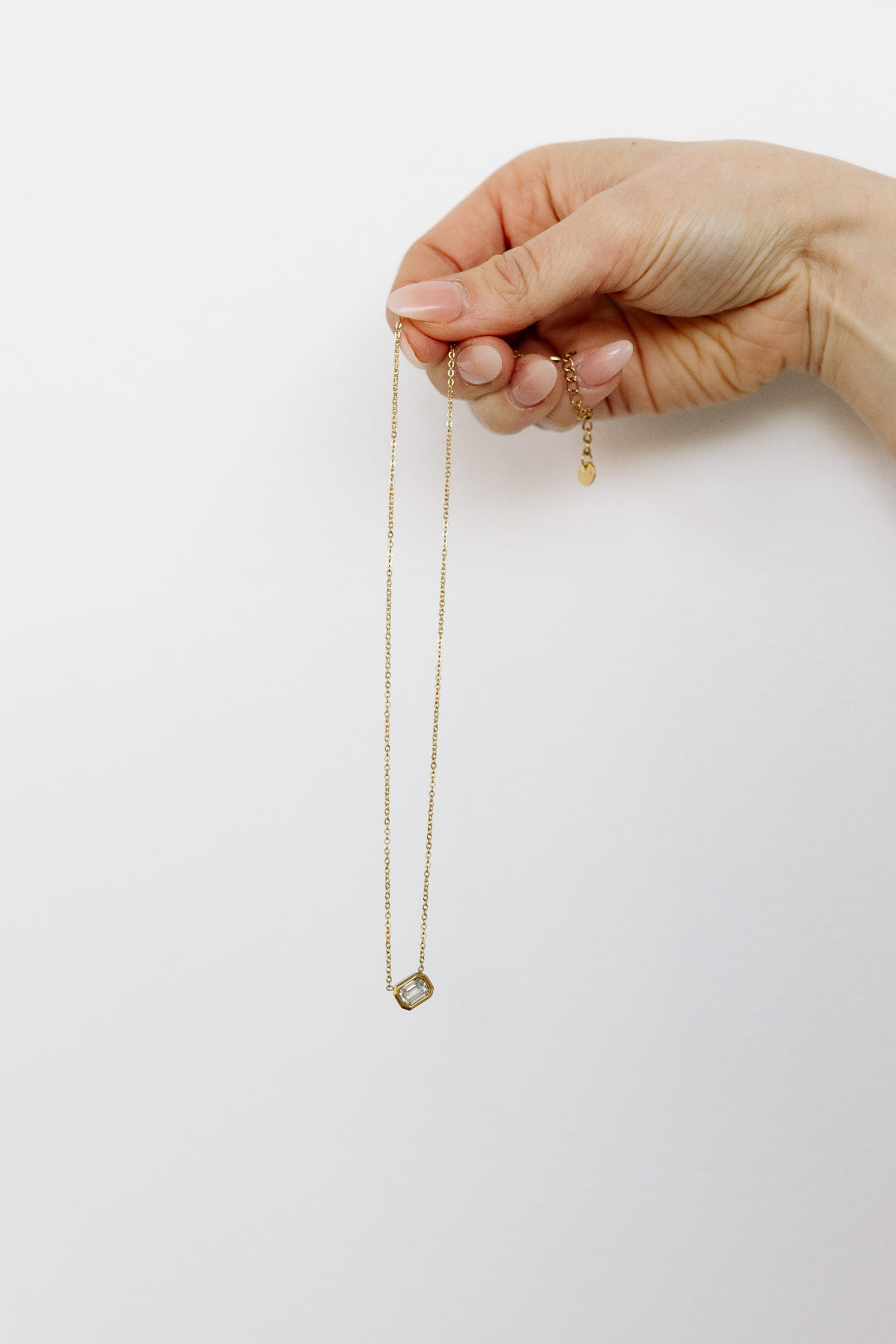 Hand holding crystal necklace