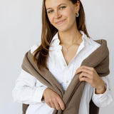 Full body model with cross necklace and pearl earrings