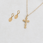 White flat lay of huggies and necklace