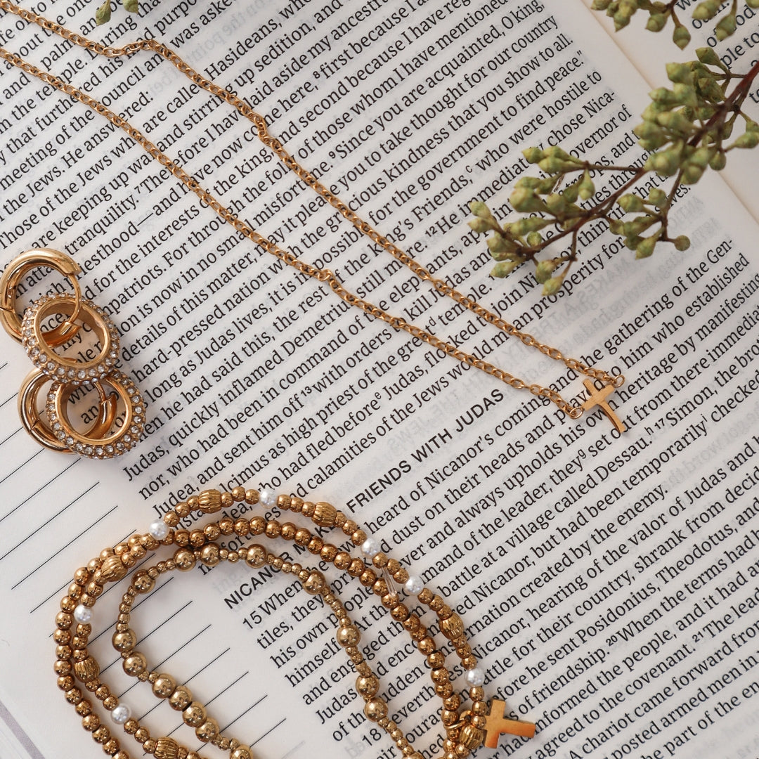 Bracelet stack with earrings and necklace on Bible