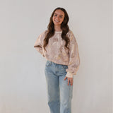 Brunette model in crewneck and jeans