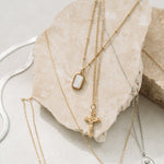 Gold catholic necklaces on rock