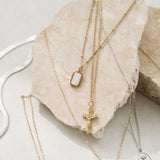 Gold catholic necklaces on rock