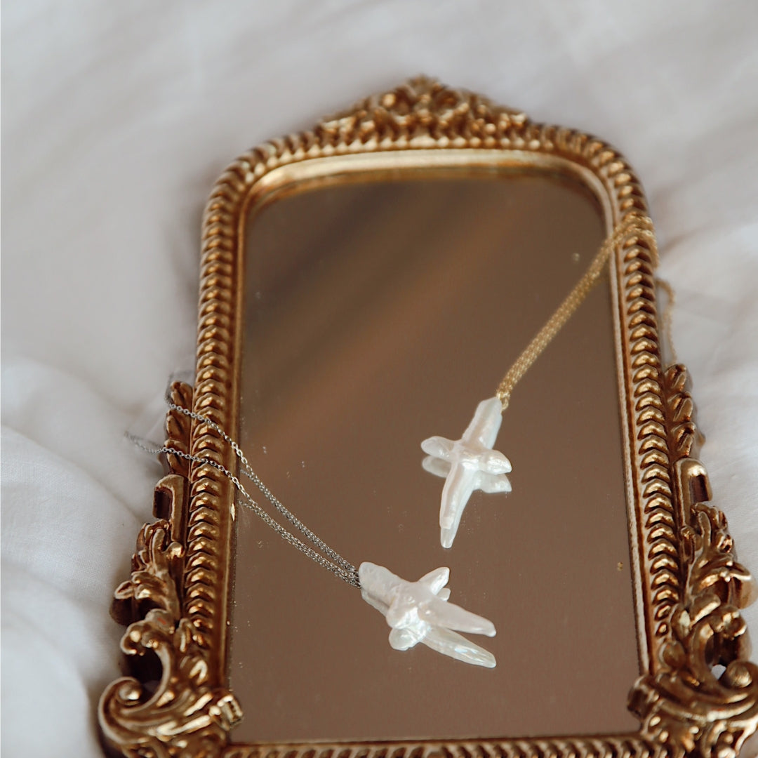 Pearl cross necklaces on mirror