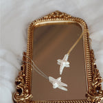 Pearl cross necklaces on mirror