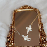 Pearl cross necklaces on mirror