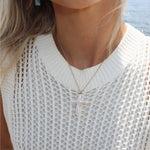 Close up pearl cross with white sweater