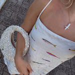 Outfit with gold pearl cross