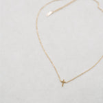 White background cross necklace