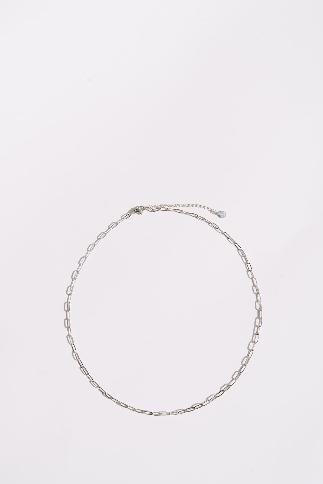 Zoomed out silver necklace white background
