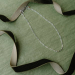 Green background silver necklace