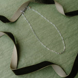 Green background silver necklace