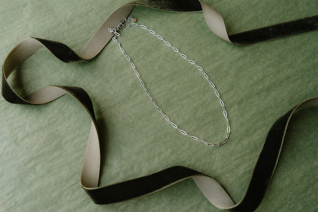 Green background silver necklace